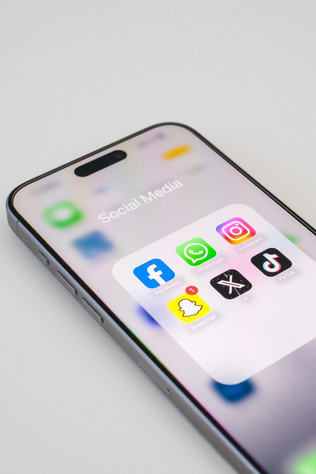 a-close-up-of-an-iphone-on-a-white-surface-r7dxww7fyh8